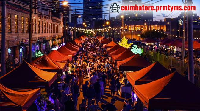 Night street market with red tents, decorative lights, and large crowd enjoying shopping and food stalls